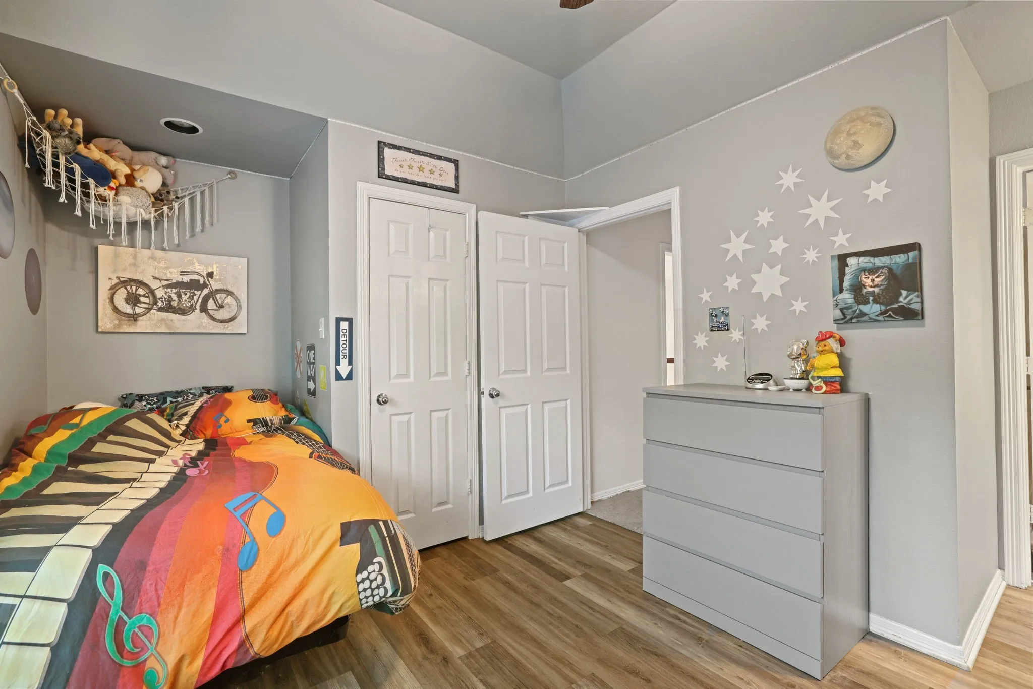 Room featuring wood-finish flooring, light gray wall paint, and white trim