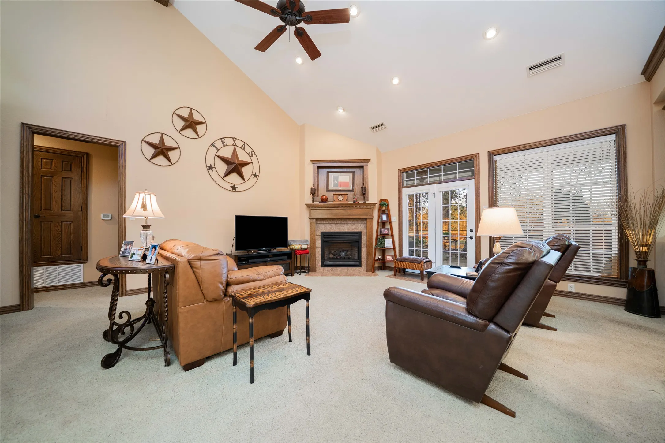 Spacious living area featuring a vaulted ceiling with a ceiling fan, recessed lighting, and light-toned carpeting