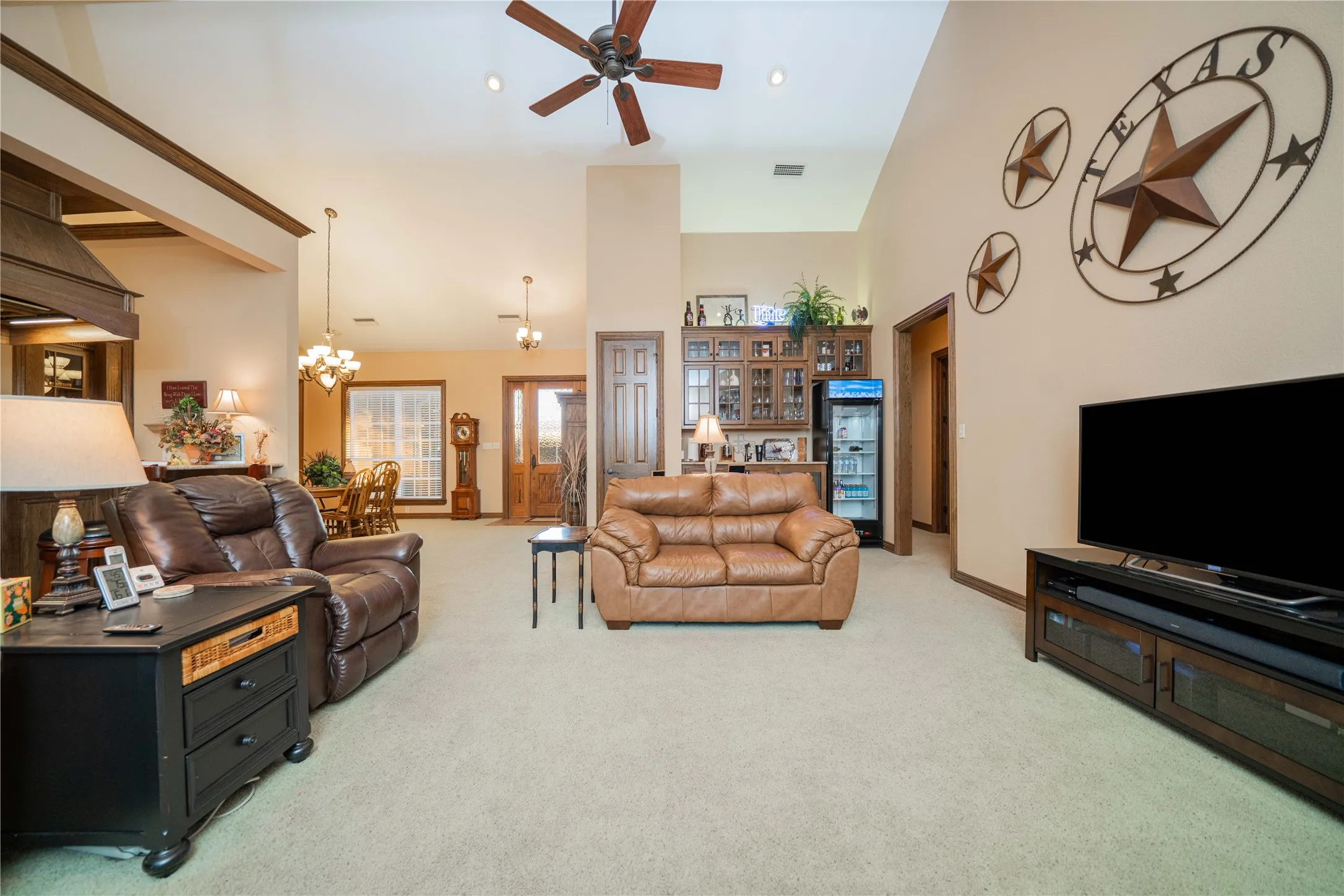 Expansive living area with vaulted ceilings and a ceiling fan