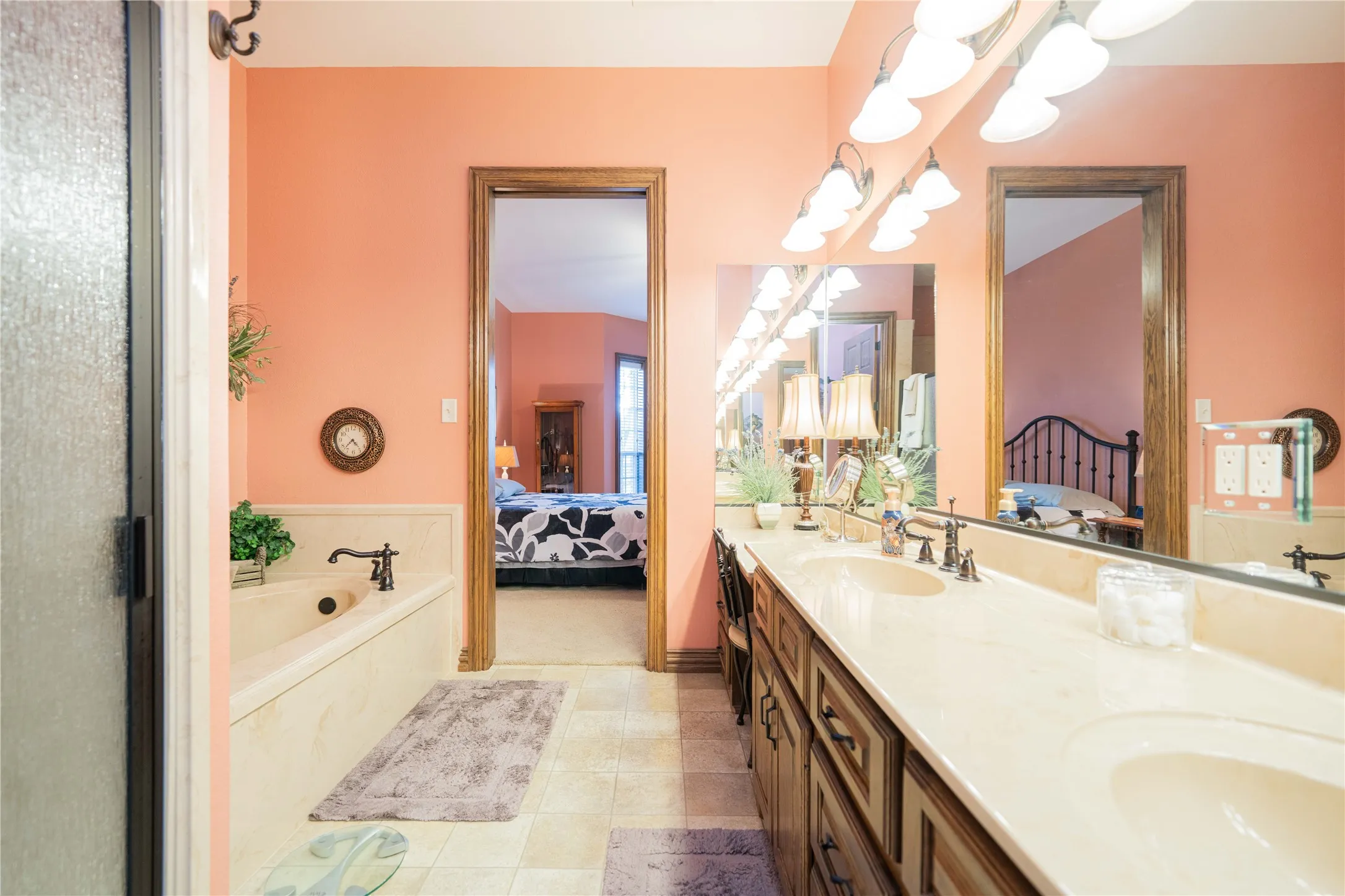 Dual vanity with light-colored countertops, undermount sinks, and dark bronze fixtures