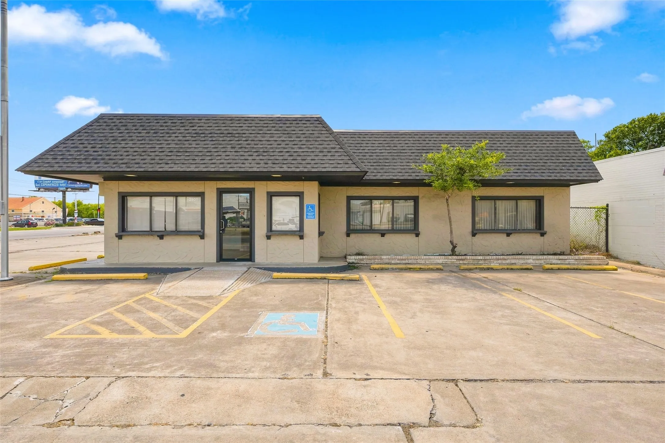 Commercial building featuring a dark shingle roof and neutral-toned exterior