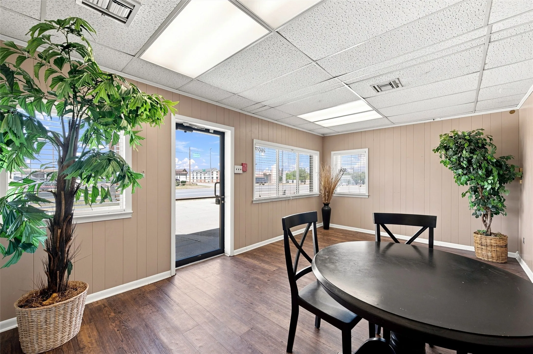 Commercial interior with wood-finish flooring and light beige vertical paneling