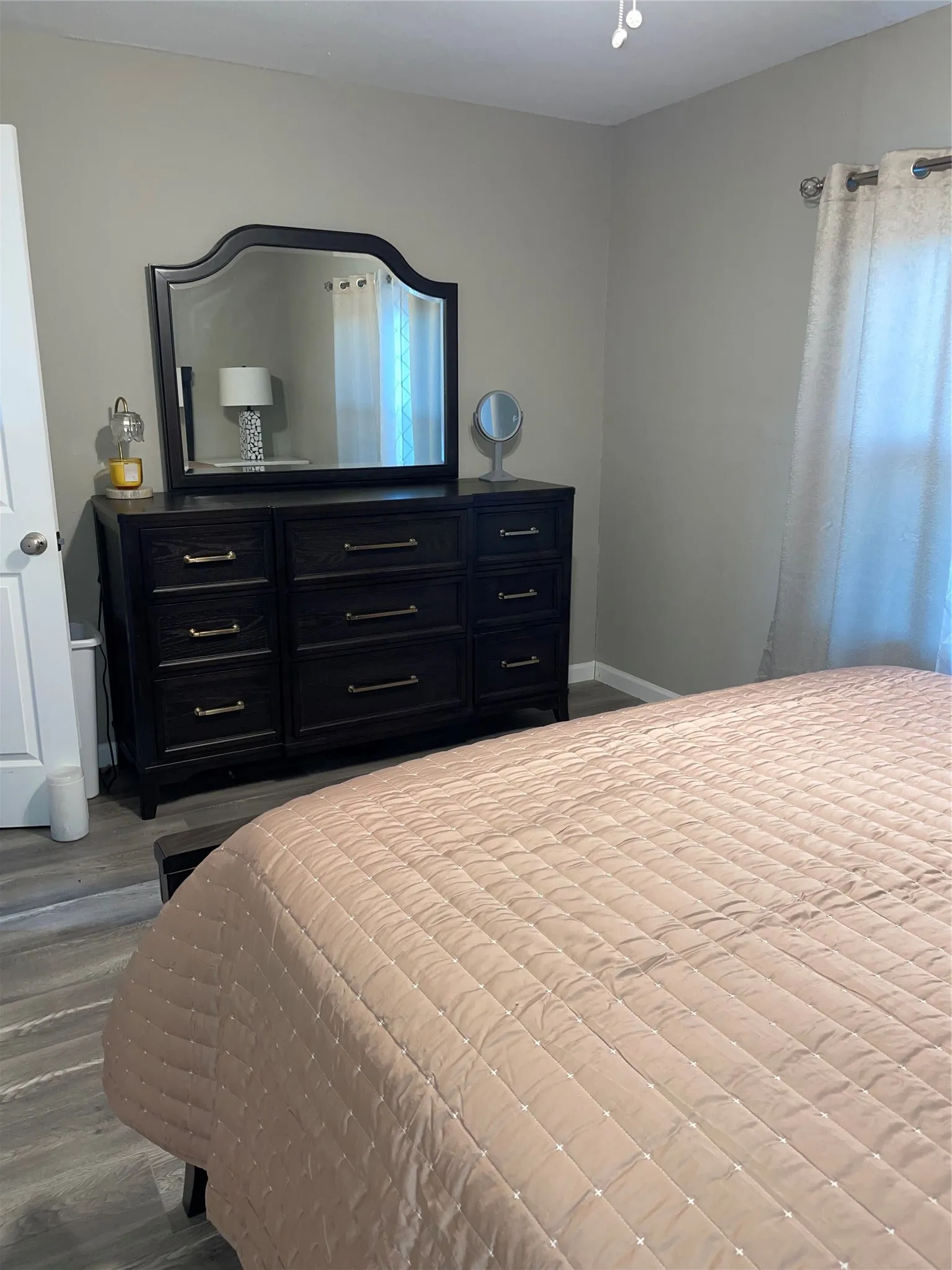 Bedroom featuring wood-finish flooring and neutral wall tones