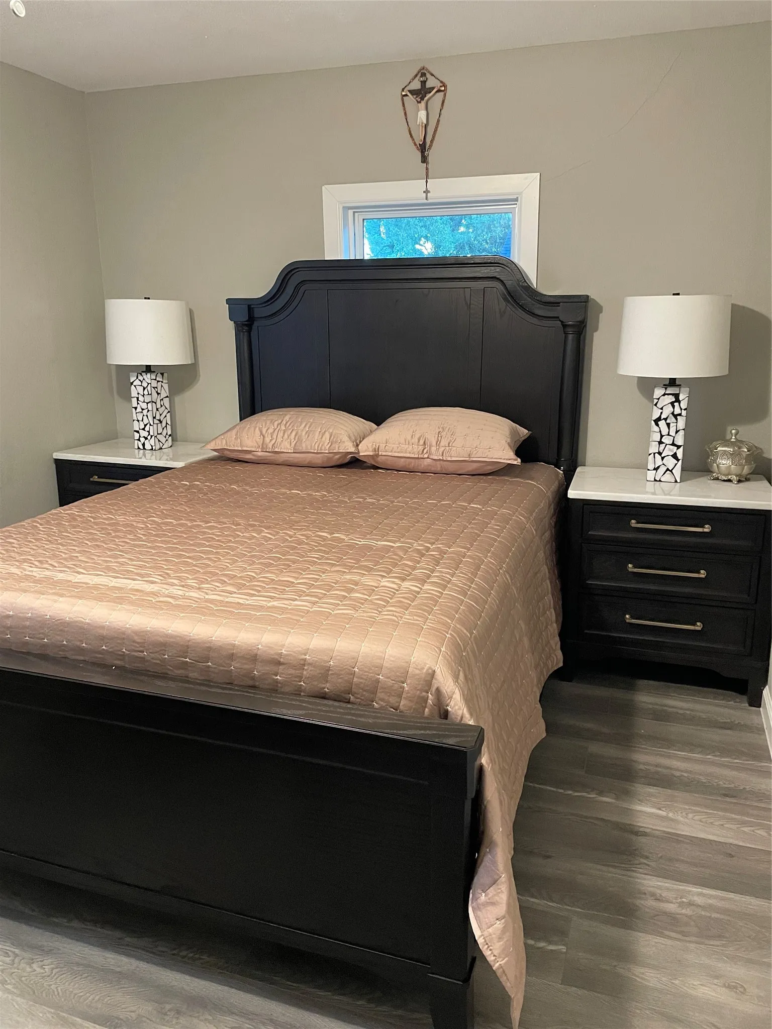 Bedroom featuring light gray wall paint and wood-finish flooring