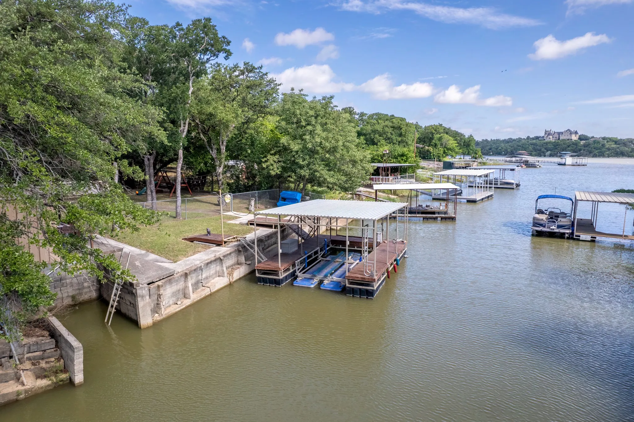 A strong concrete retaining wall lines the waterfront.