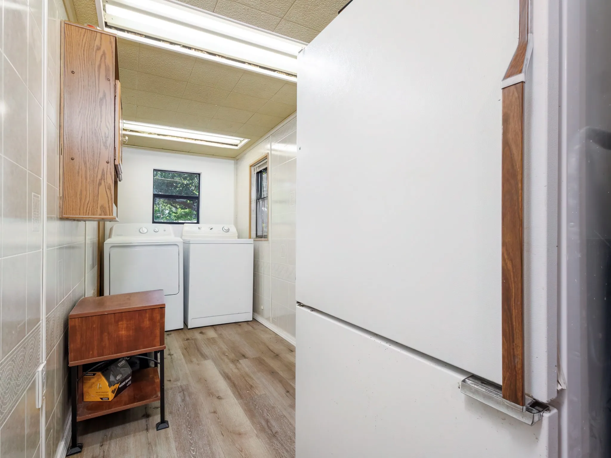 The utility room is spacious and has enough room for a fridge.