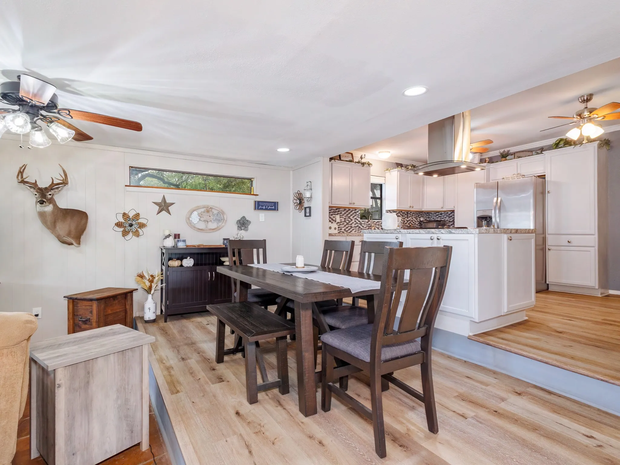 Step up to the updated kitchen with an island and dining area.