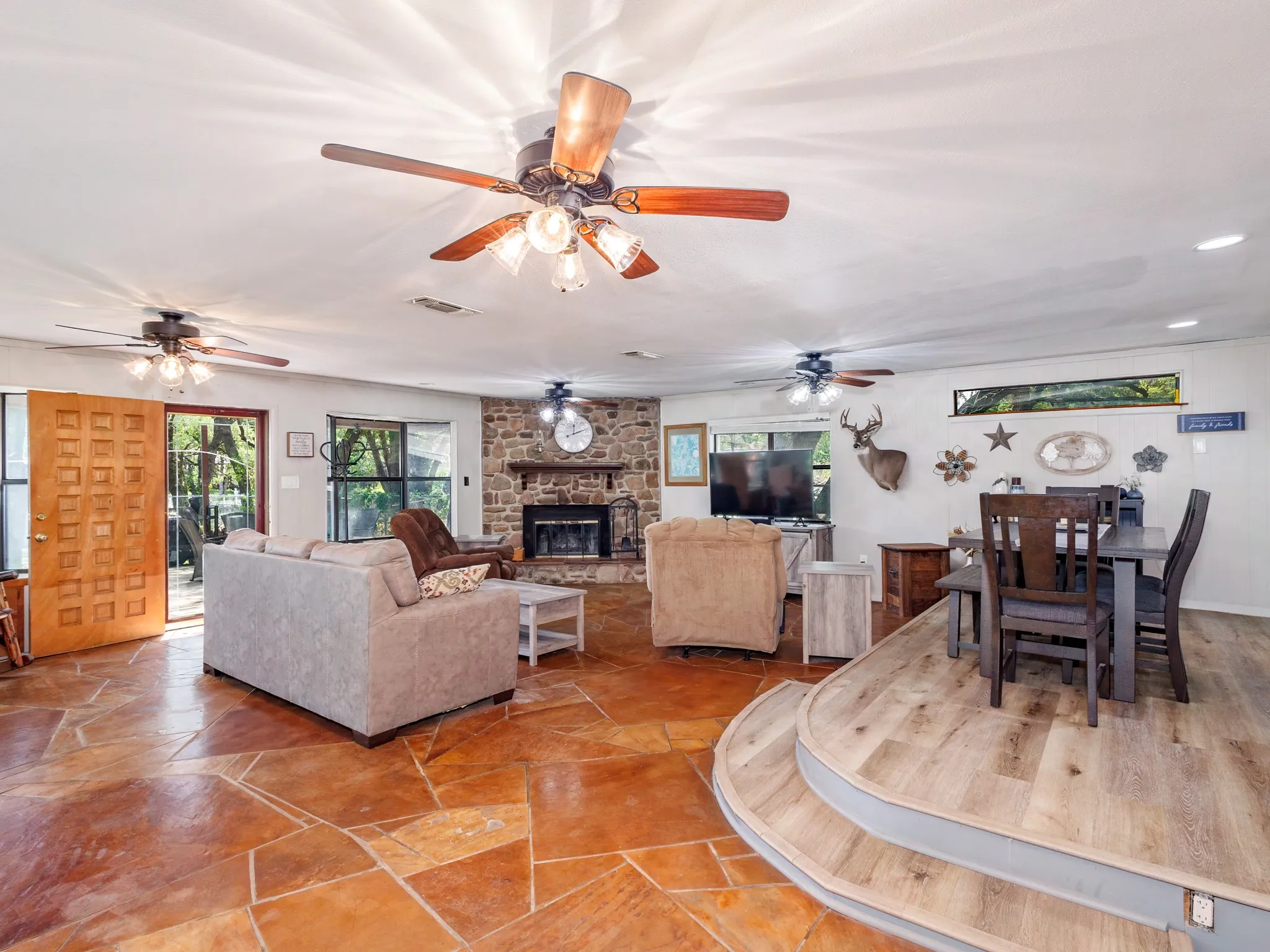 The spacious living room features a wood-burning fireplace and lake views.