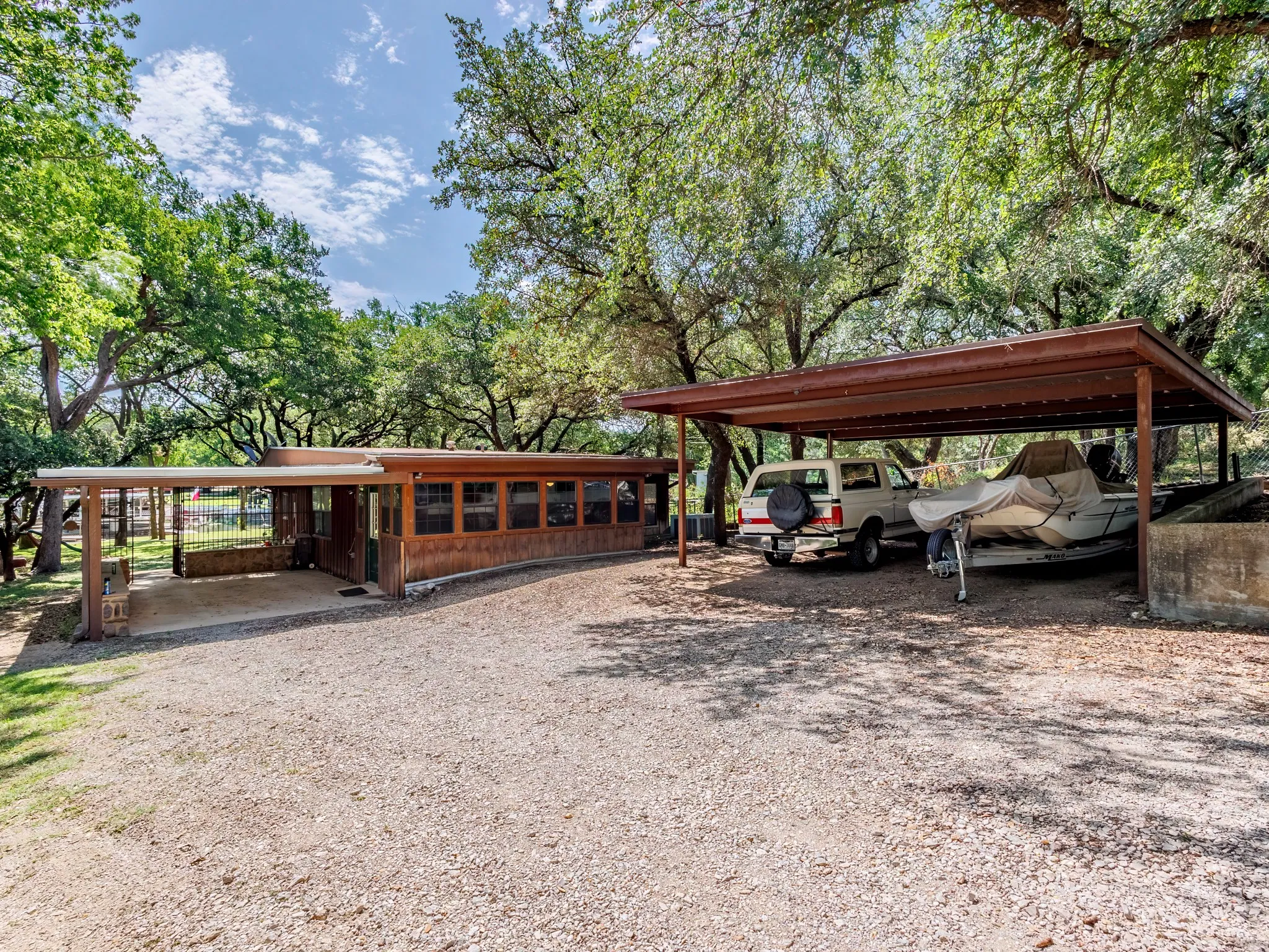 Two carports offer covered parking with room for a boat or RV.