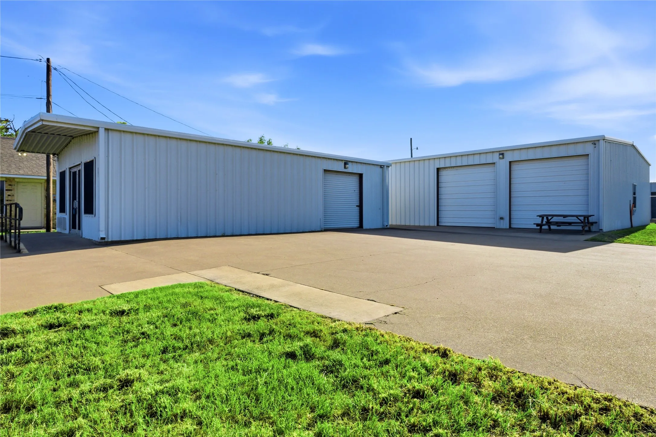 Both buildings with view of 2 garage doors on large building