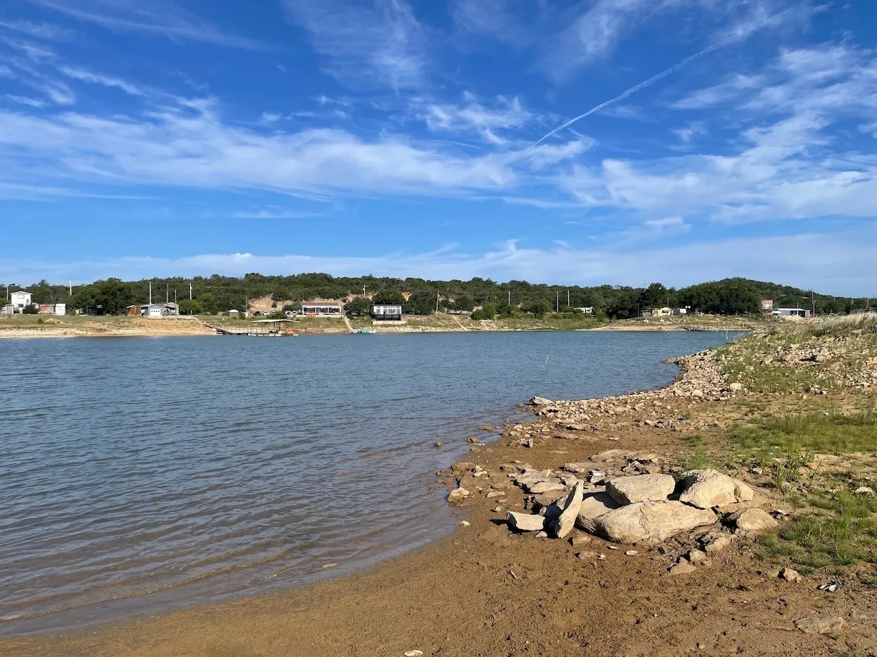 Expansive waterfront property featuring a natural shoreline, mature trees, and direct water access
