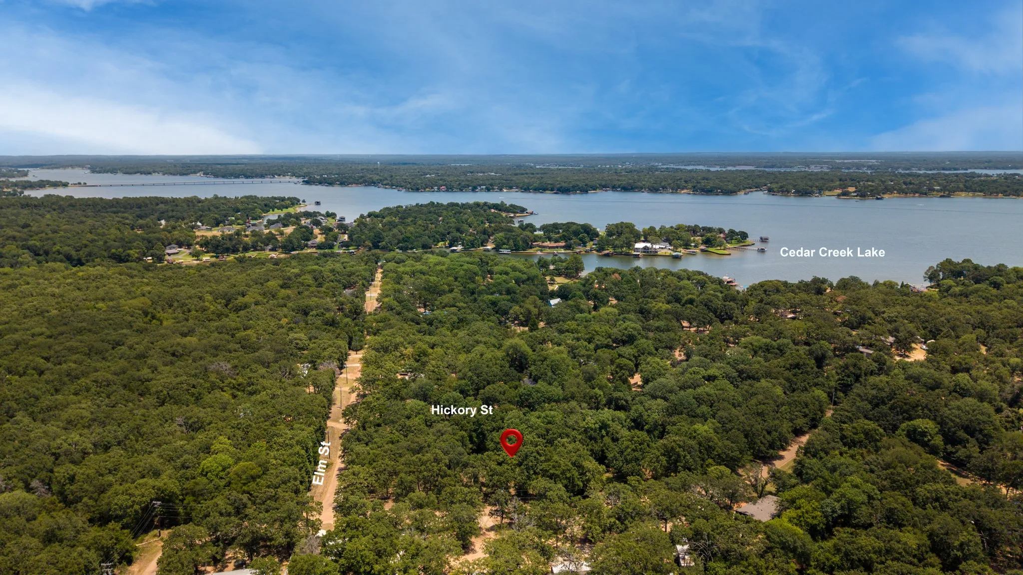 Aerial perspective of a large wooded area with direct proximity to Cedar Creek Lake