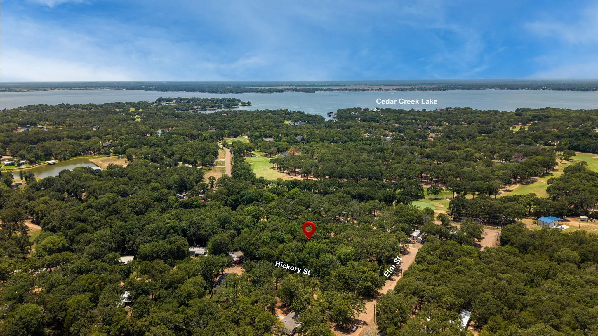 Aerial perspective featuring Cedar Creek Lake and abundant tree canopy
