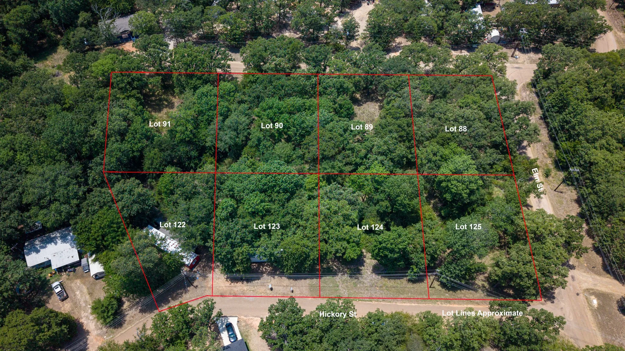 Multiple wooded parcels featuring established tree cover and direct street frontage