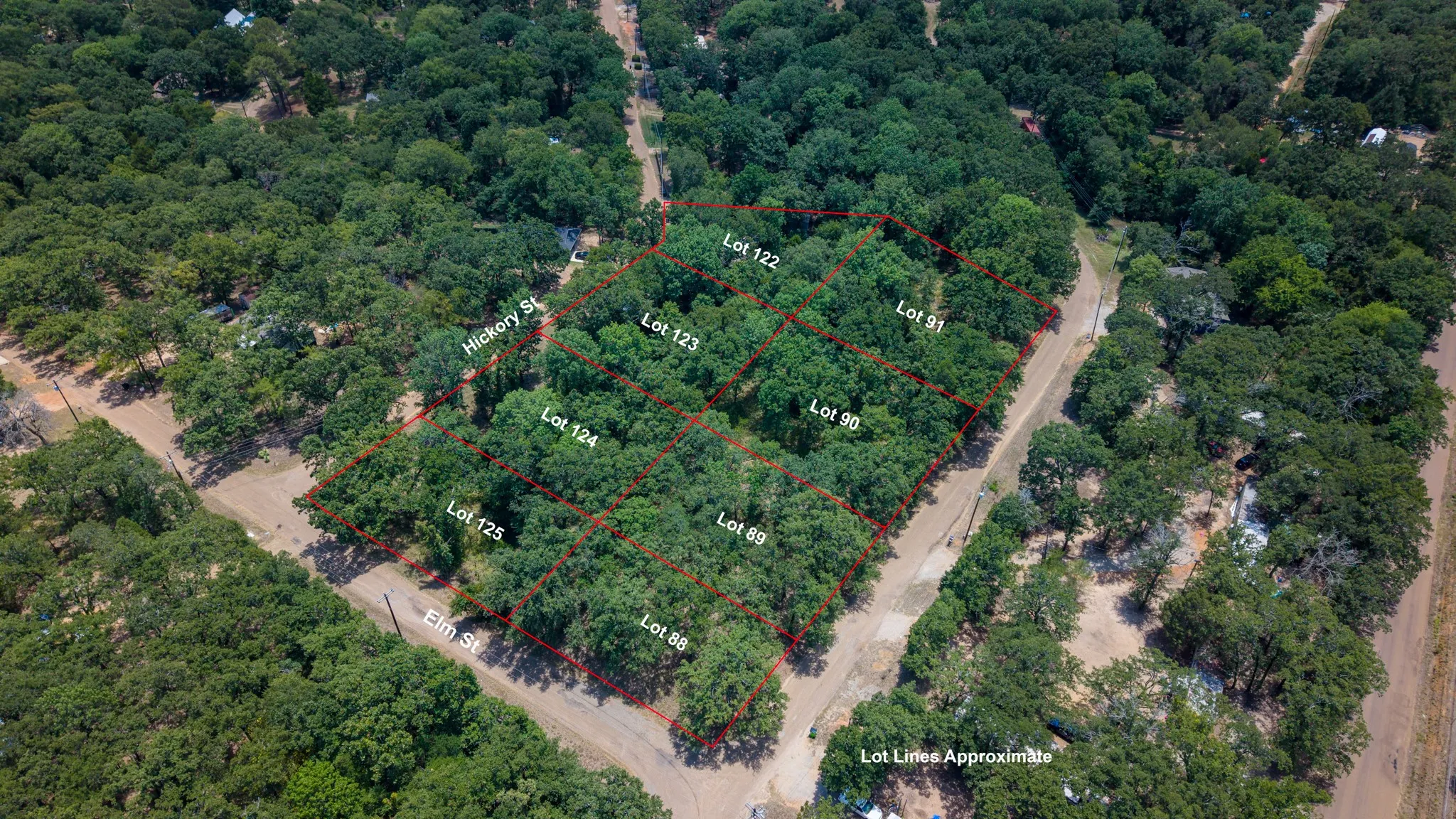 Aerial perspective of multiple undeveloped lots surrounded by mature trees