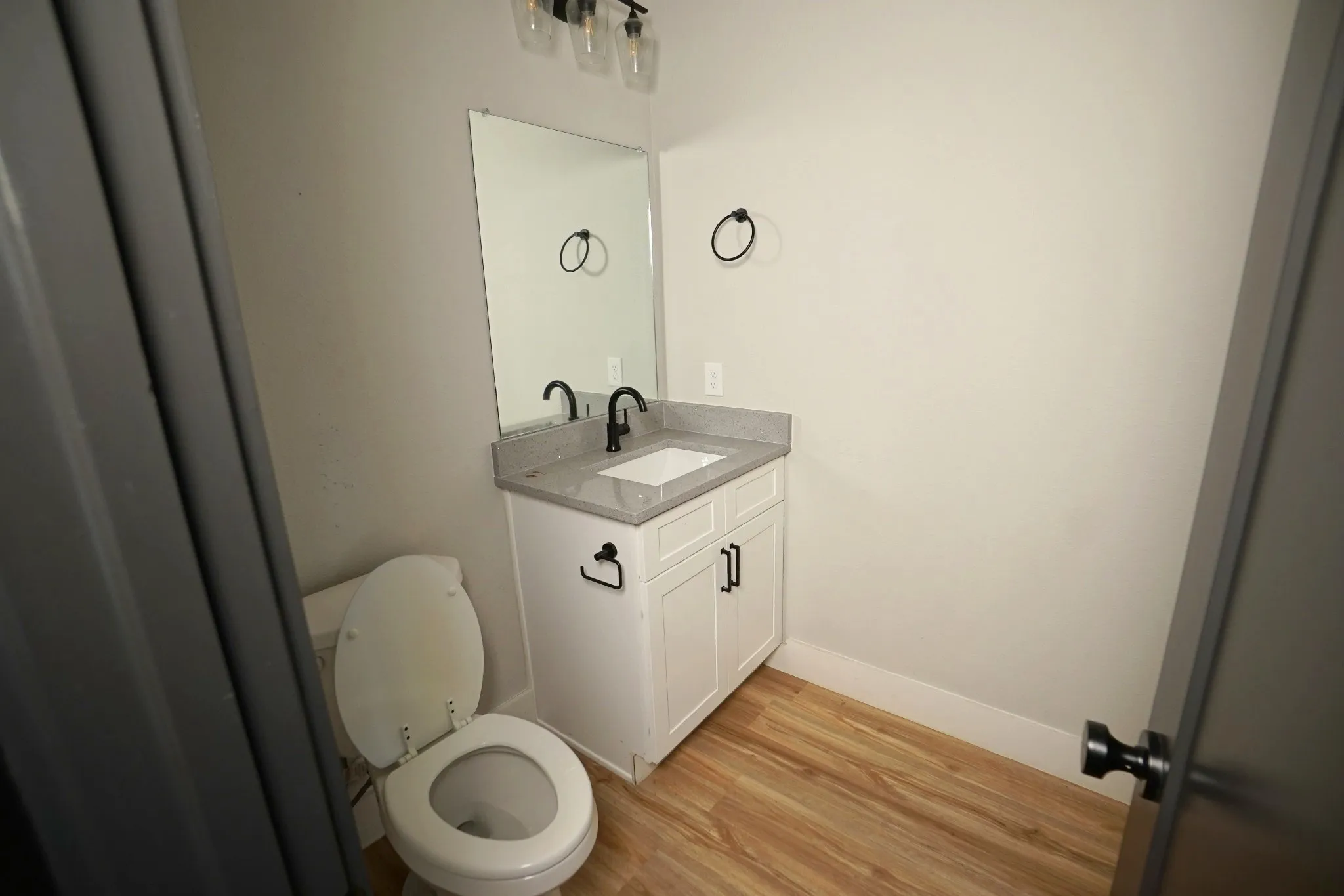 Vanity with a light-toned countertop, under-mount sink, and matte black faucet