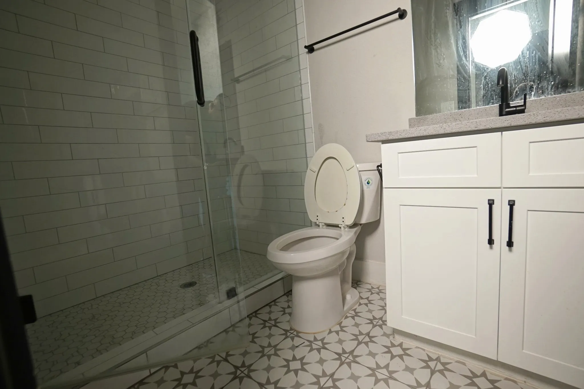 Walk-in shower with subway tile surround and glass enclosure