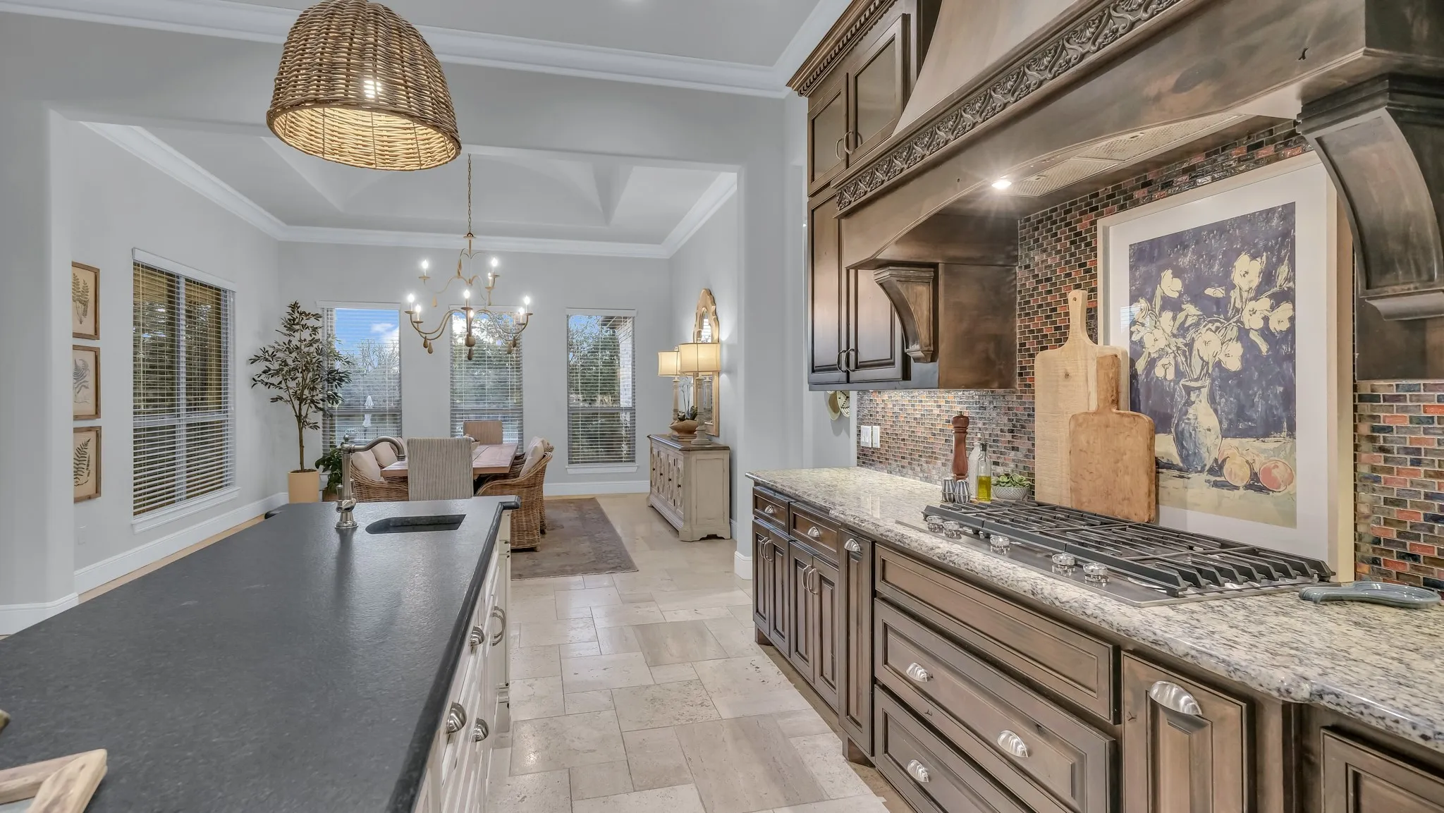 Kitchen featuring a gas range, dark wood cabinetry, granite countertops, and a mosaic tile backsplash