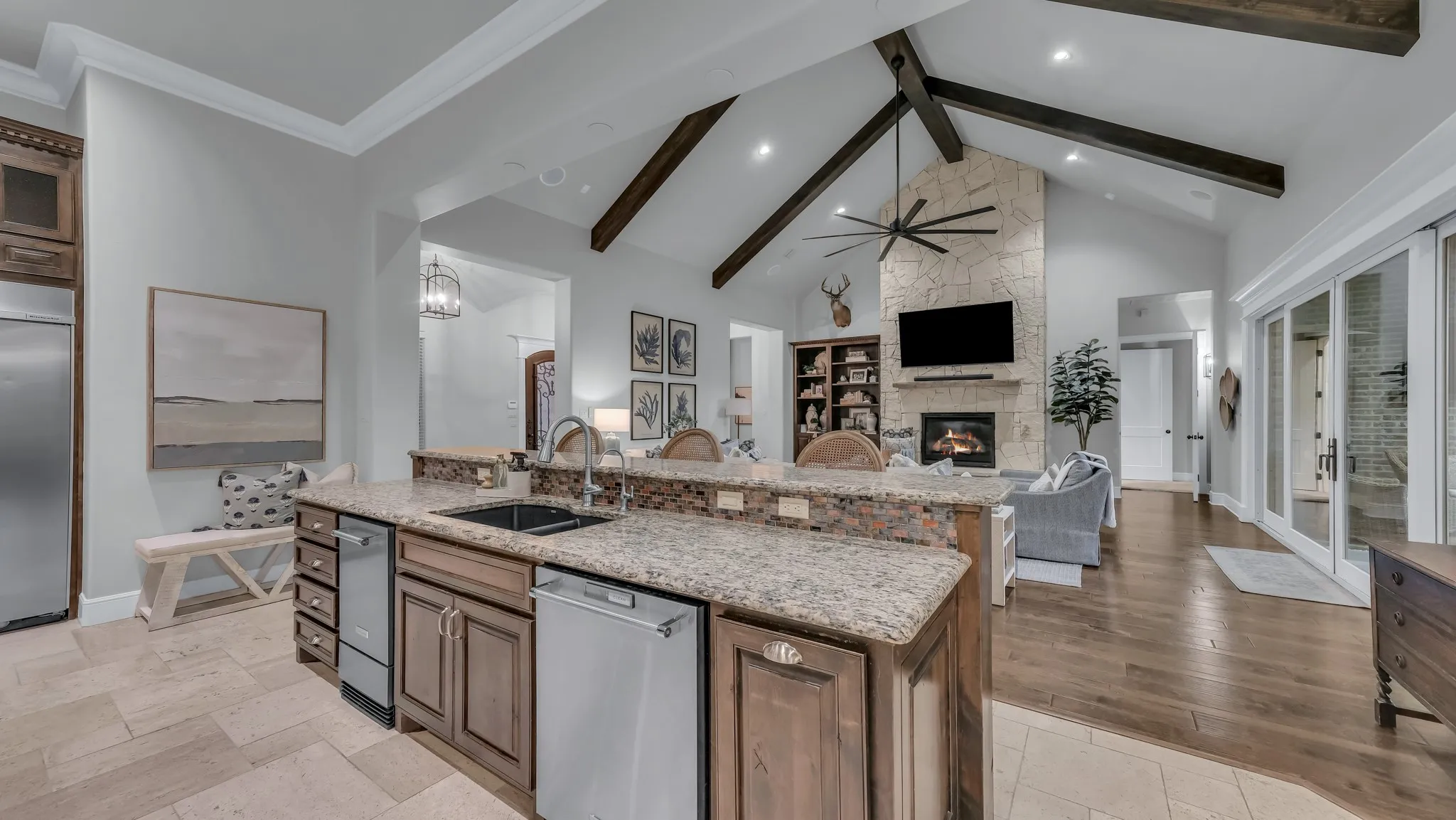 Gourmet kitchen featuring granite countertops, a dark composite sink, and integrated stainless steel appliances