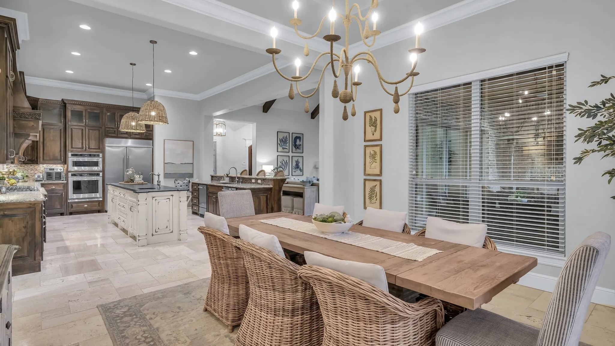 Dining area featuring a rustic wood-finish table and a statement chandelier