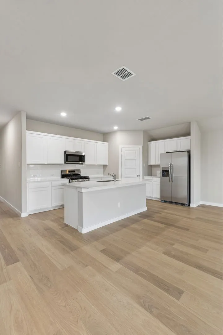Kitchen in the Emmy II home plan by Trophy Signature Homes - REPRESENTATIVE PHOTO