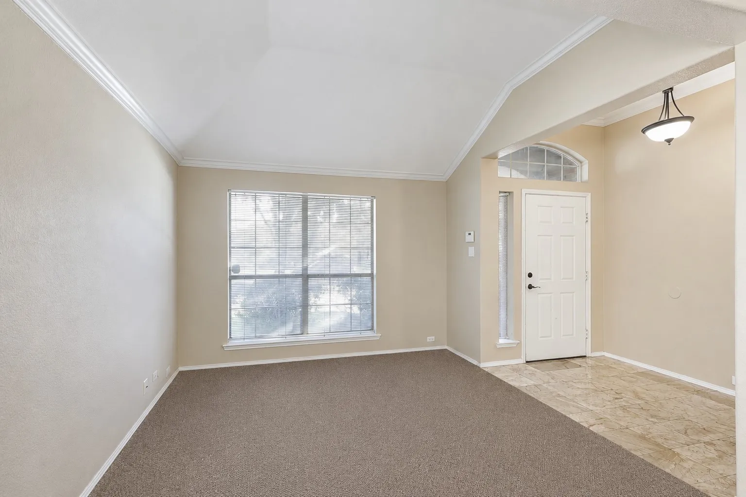 Entryway with a paneled door, transom window, and sidelight
