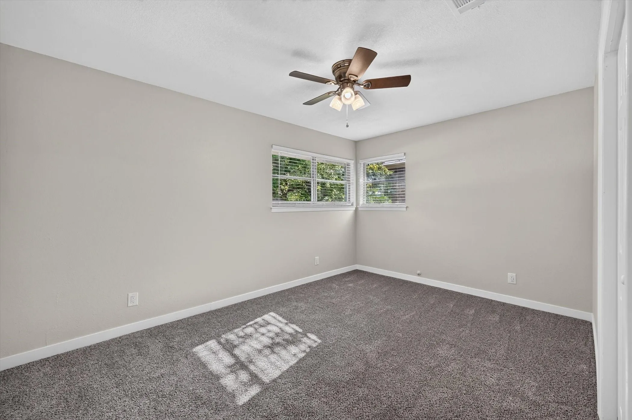 Bedroom with light gray walls and gray carpet flooring