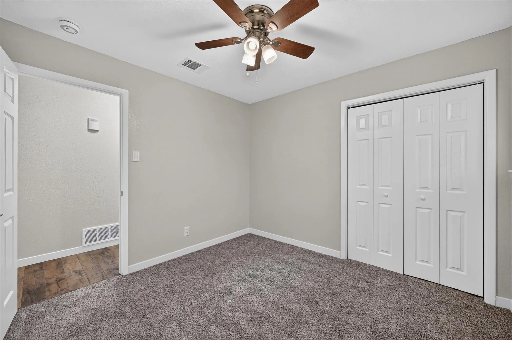 Bedroom featuring light gray walls and plush gray carpet
