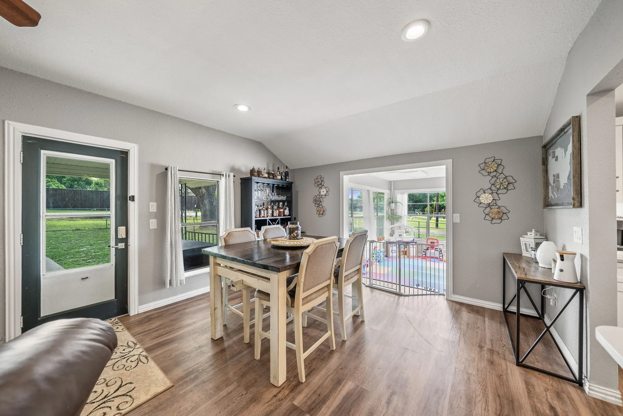 Dining area featuring wood-finish flooring, recessed lighting, and a vaulted ceiling