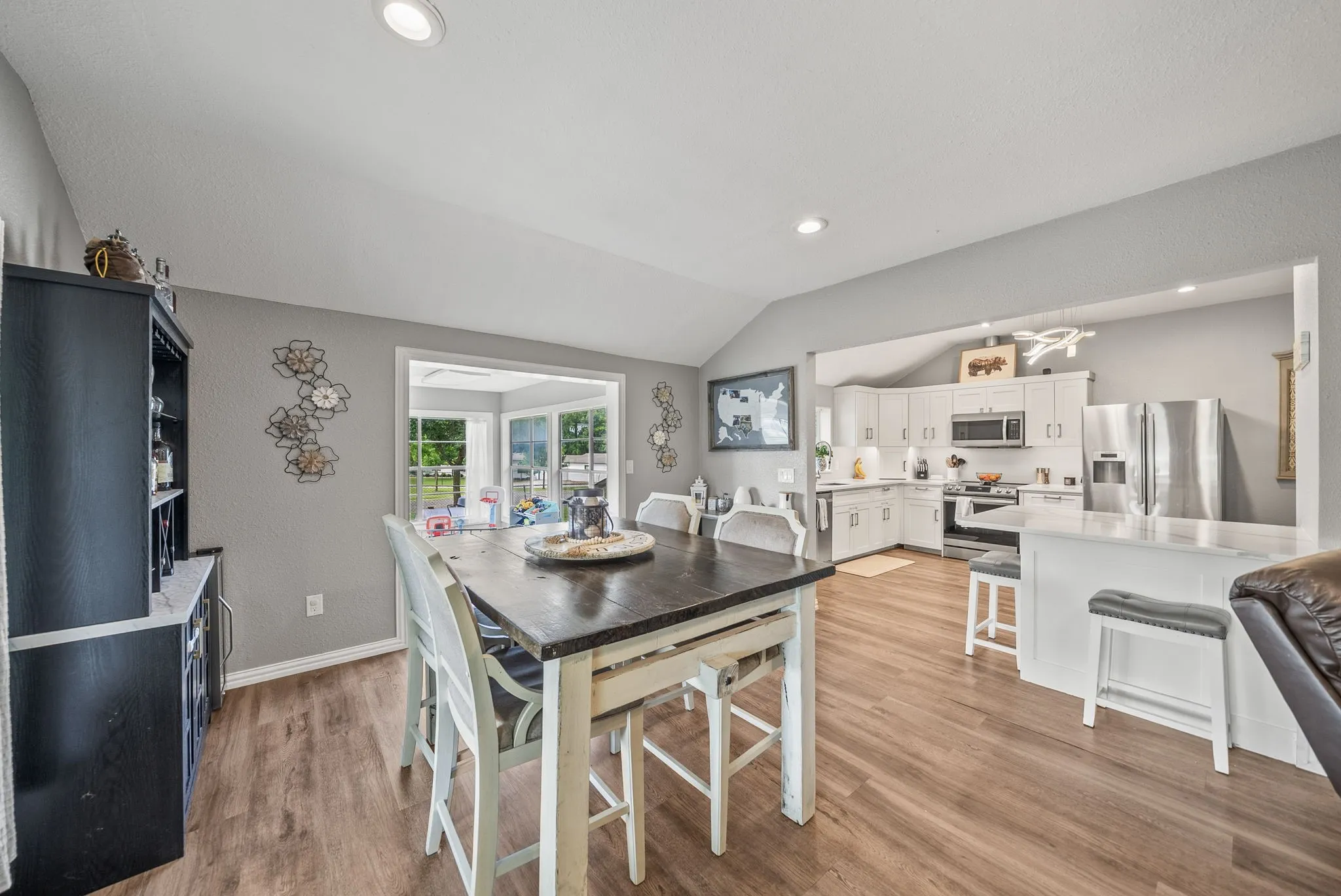 Open-concept kitchen and dining area with wood-finish flooring