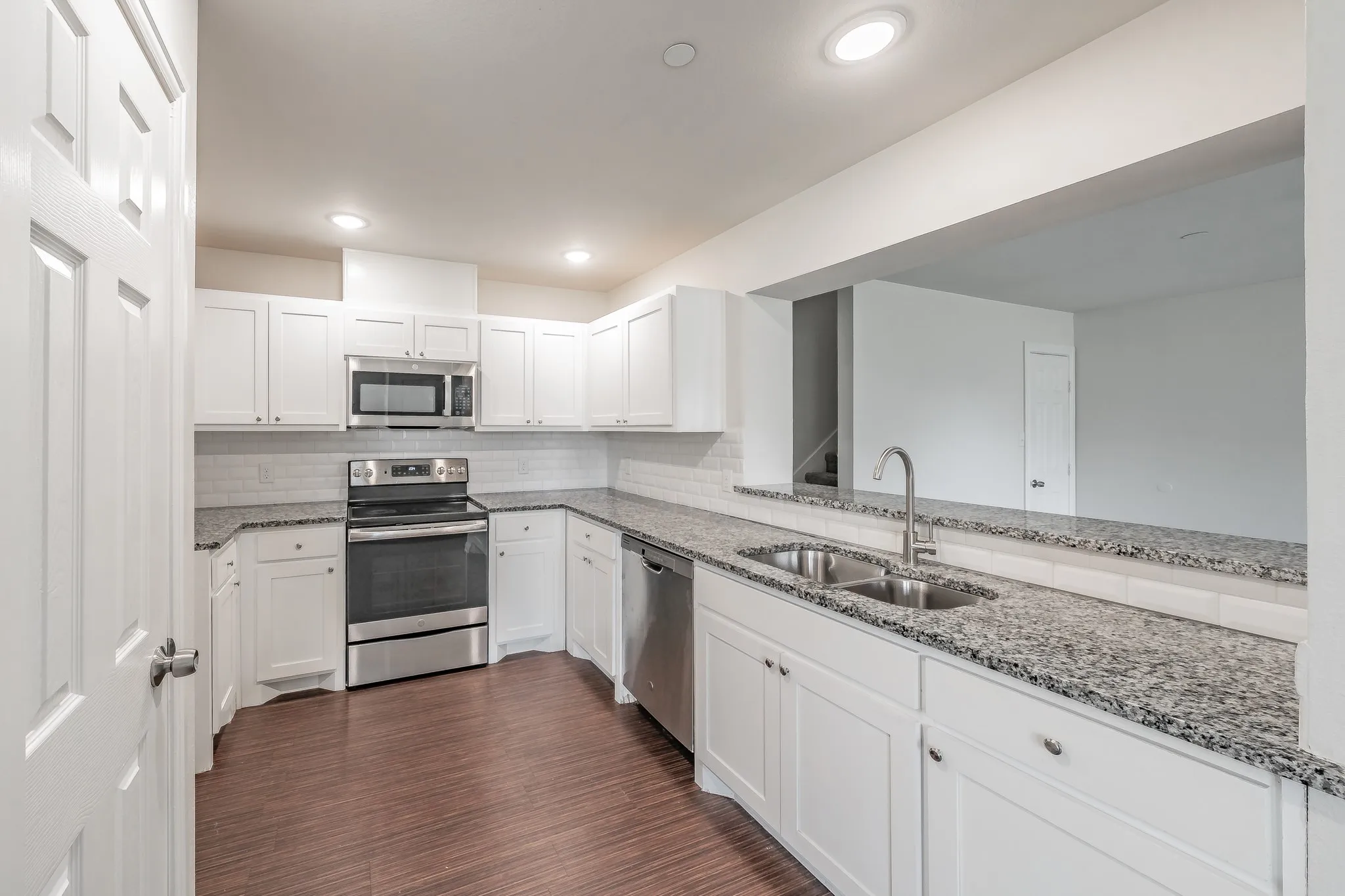 Kitchen surround by lovely granite counter top, door opens up to pantry