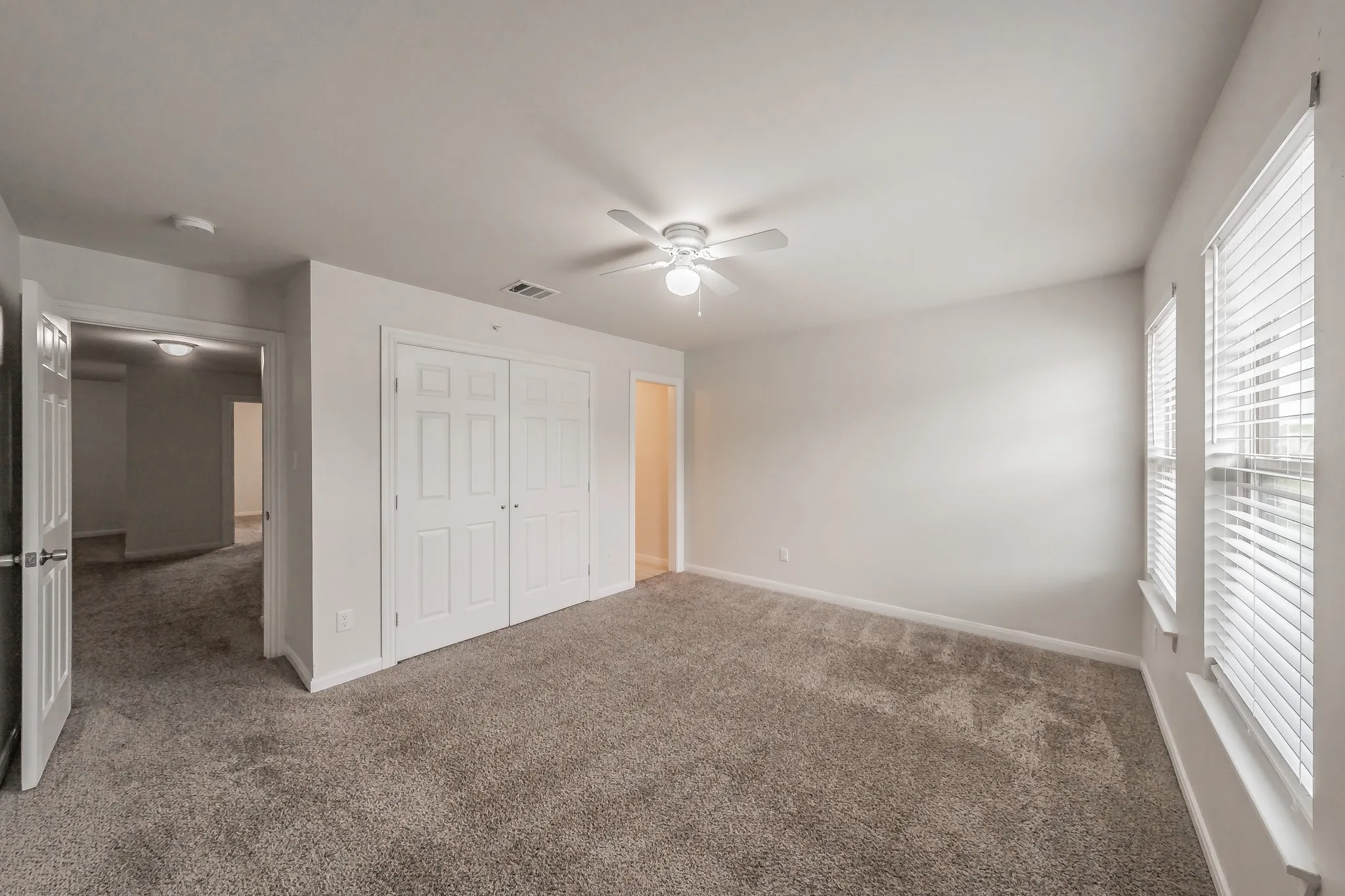 Bedroom 2 , windows faces front of property, closed door opens closet, lighted door leads to Jack and Jill restroom