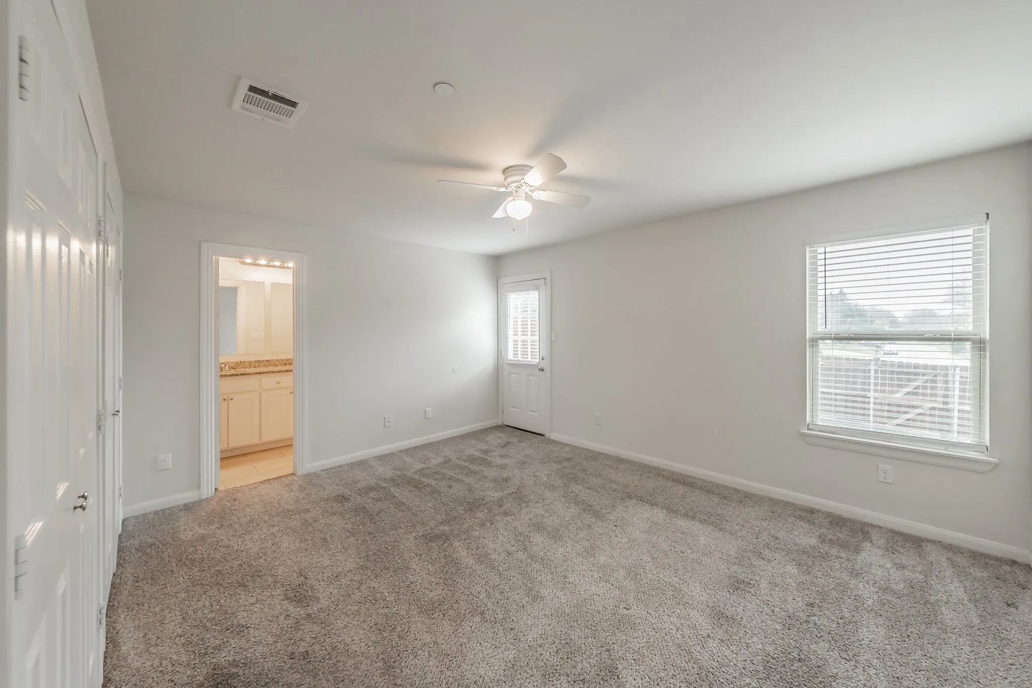Master bedroom with door leading to backyard