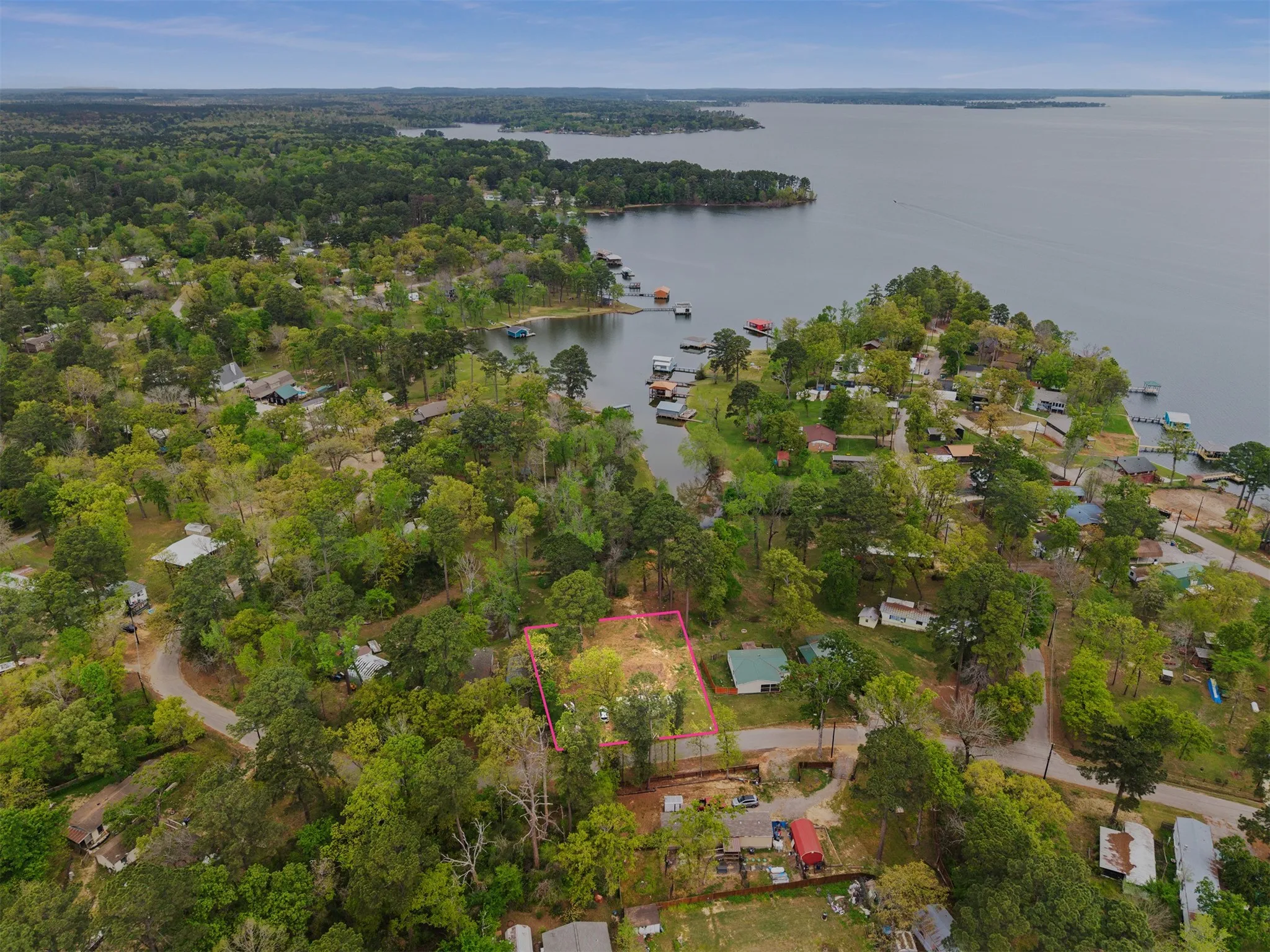 Aerial perspective showcasing a waterfront community with extensive tree coverage