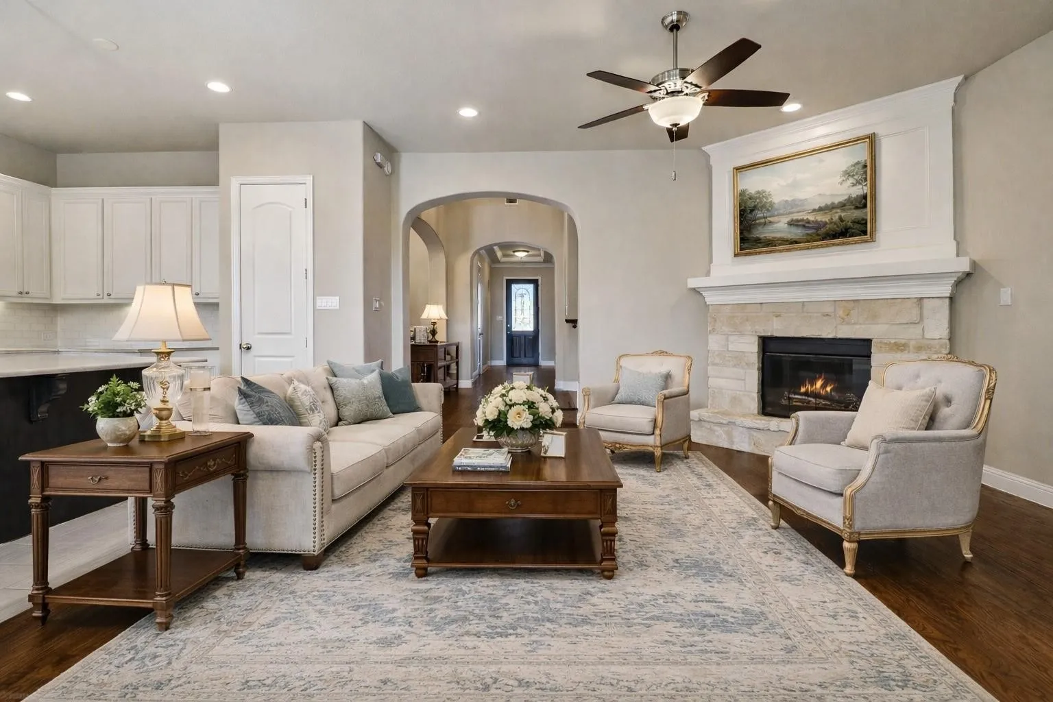 Virtual image. Living area featuring a stone-clad fireplace with a substantial mantel, wood-finish flooring, recessed lighting, and a ceiling fan
