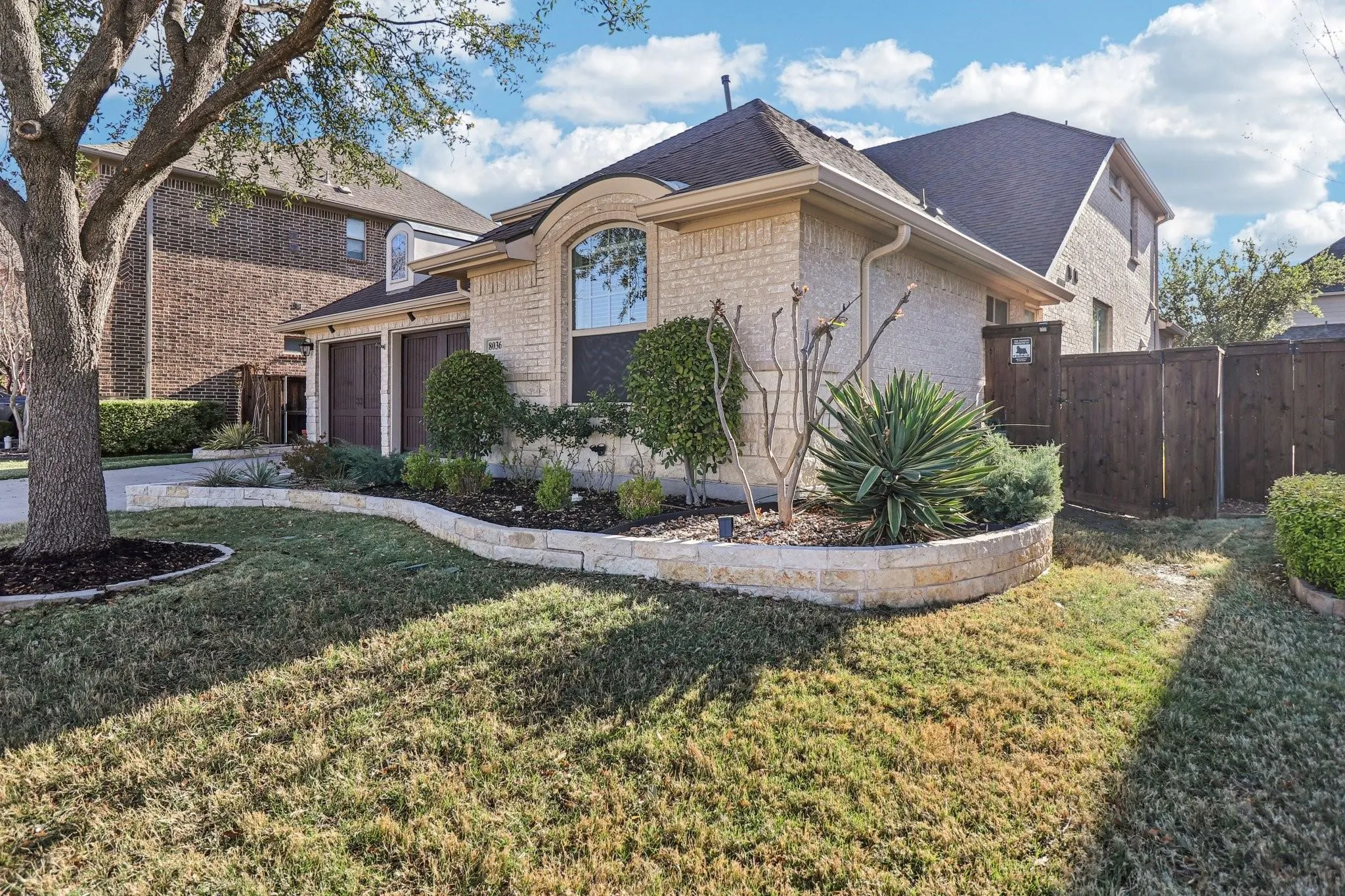 Stone veneer exterior with an arched window accent