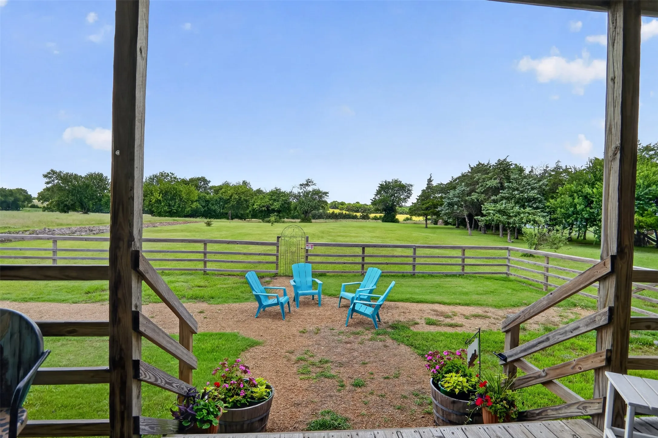 Outdoor sitting area with a gravel patio and a split-rail fence