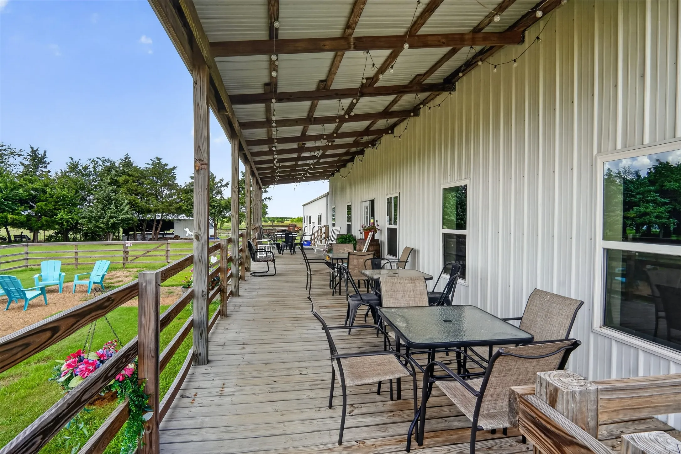 Spacious covered porch with wood-finish decking and exposed beam ceiling