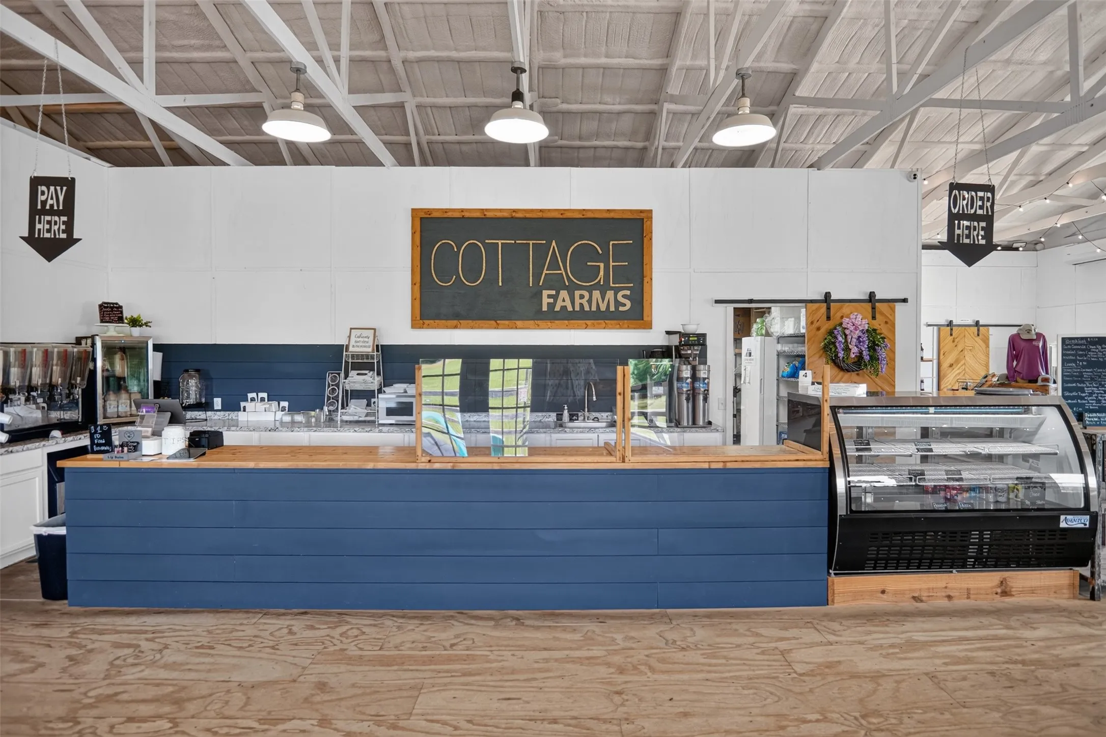 Retail counter with blue shiplap facing and wood-finish countertop