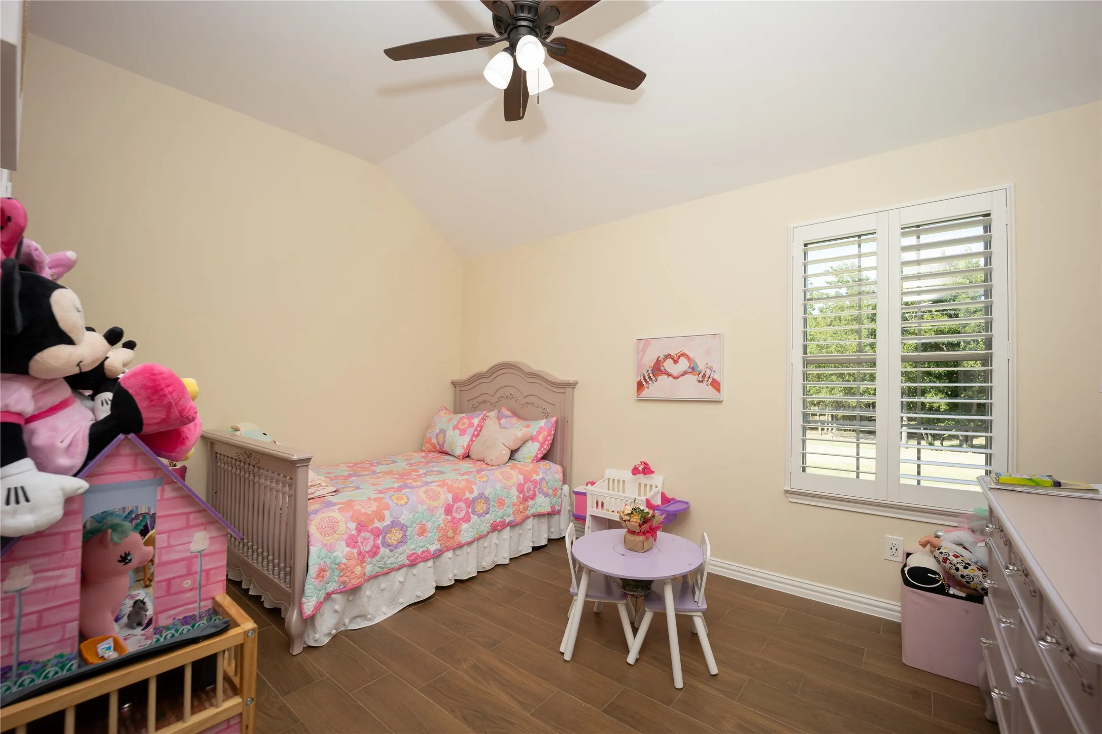 Room featuring vaulted ceilings and wood-finish flooring