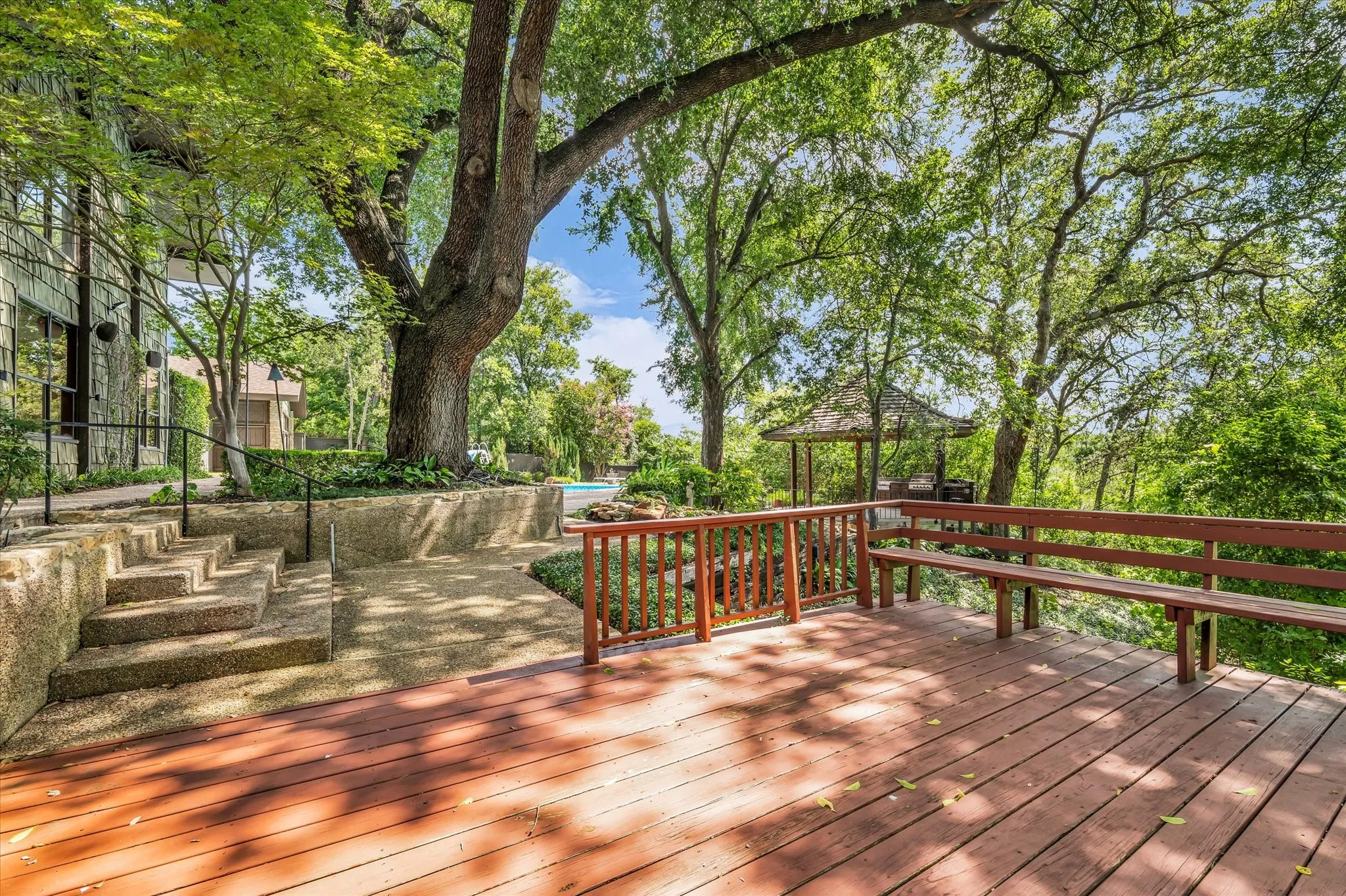 Expansive wood deck with integrated bench seating and wood railing