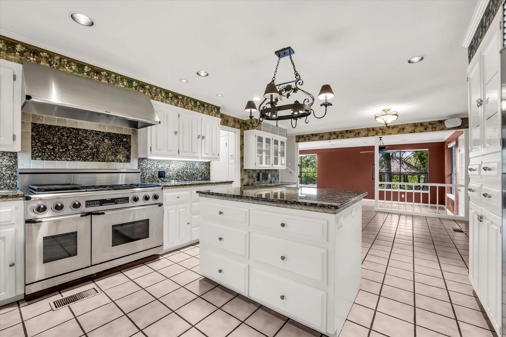 Kitchen featuring white cabinetry, granite countertops, and tile flooring