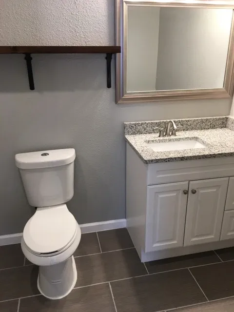 Bathroom featuring tile flooring, vanity, and toilet