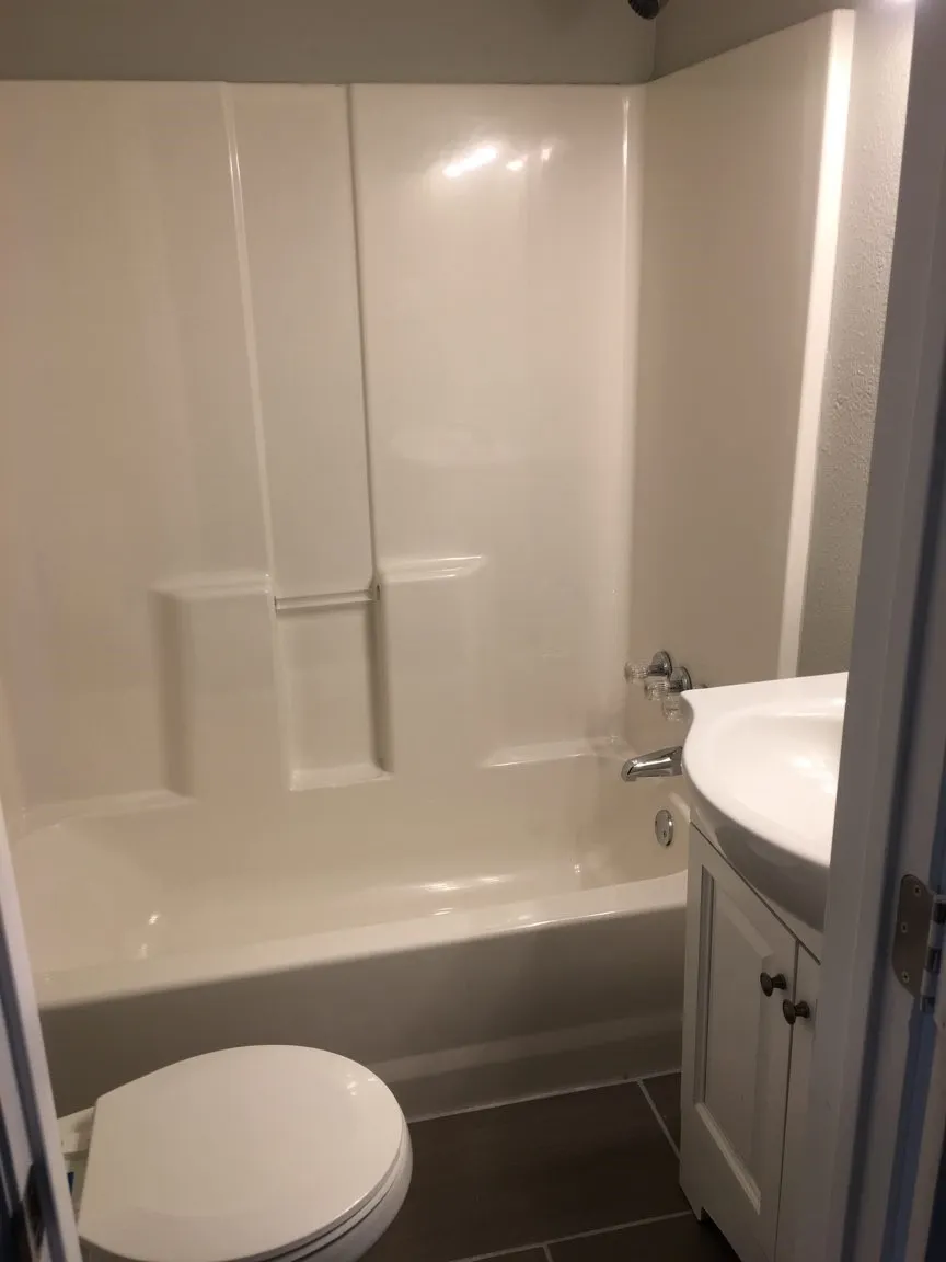 Full bathroom featuring shower / bathing tub combination, vanity, toilet, and tile floors