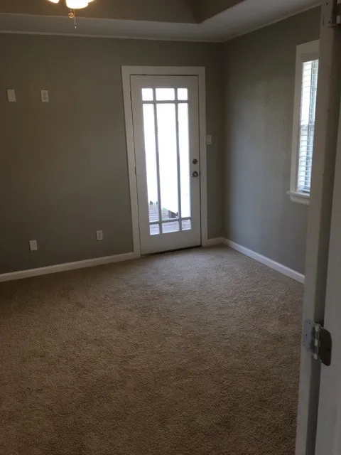 Carpeted spare room with a healthy amount of sunlight
