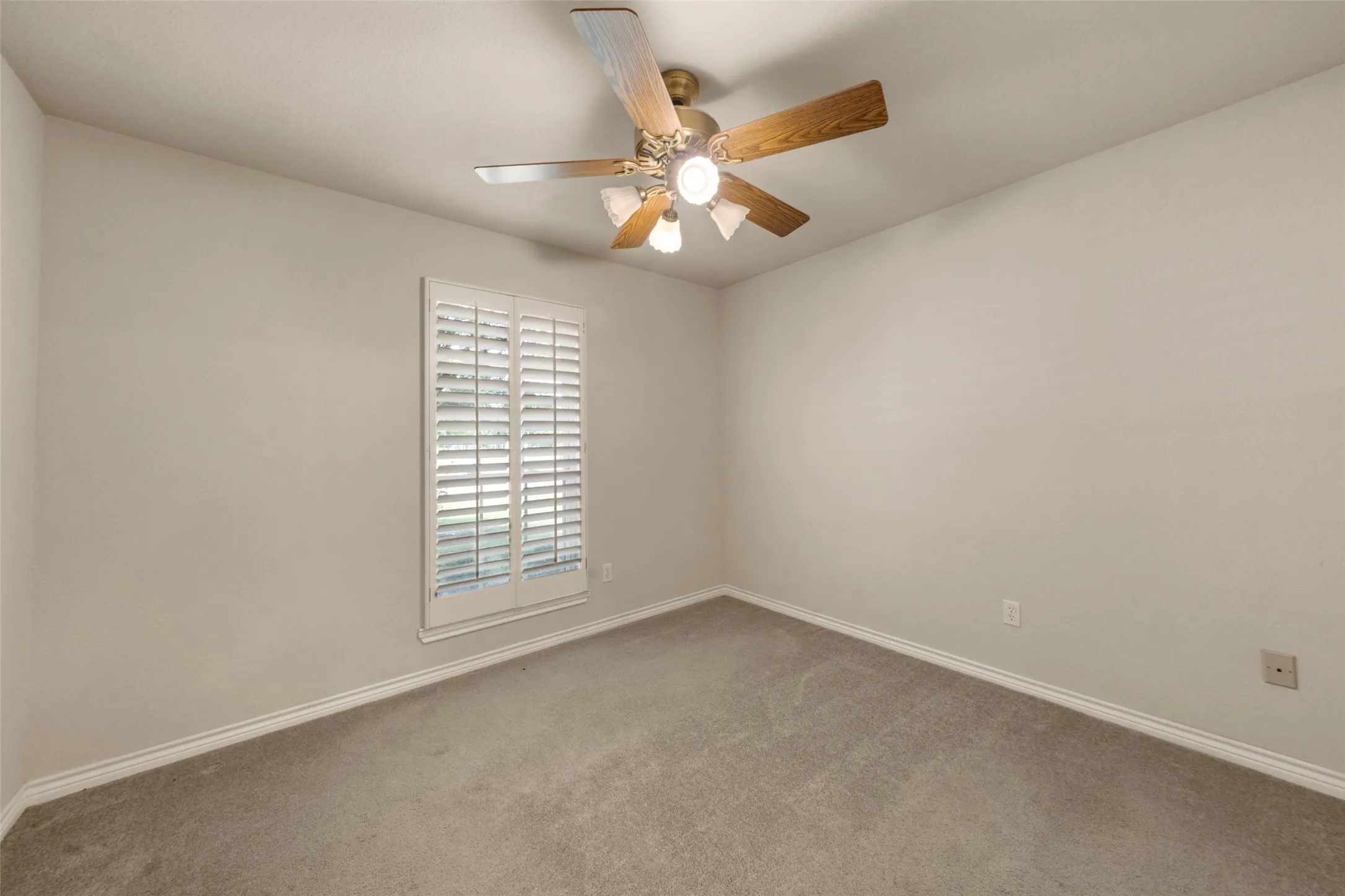 Neutral-toned walls complement plush carpet flooring