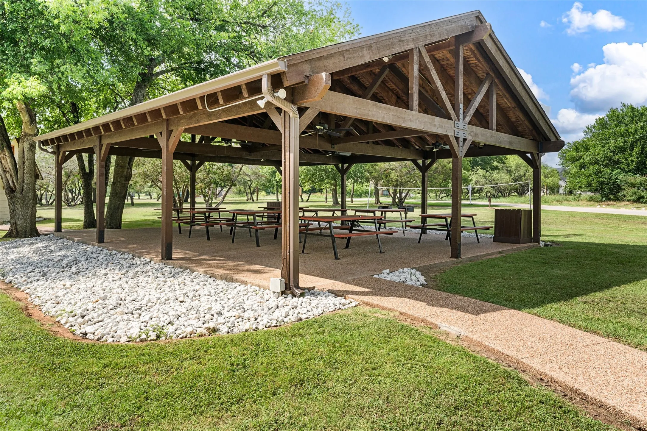 Expansive wooden pavilion with a gabled roof and exposed beam construction