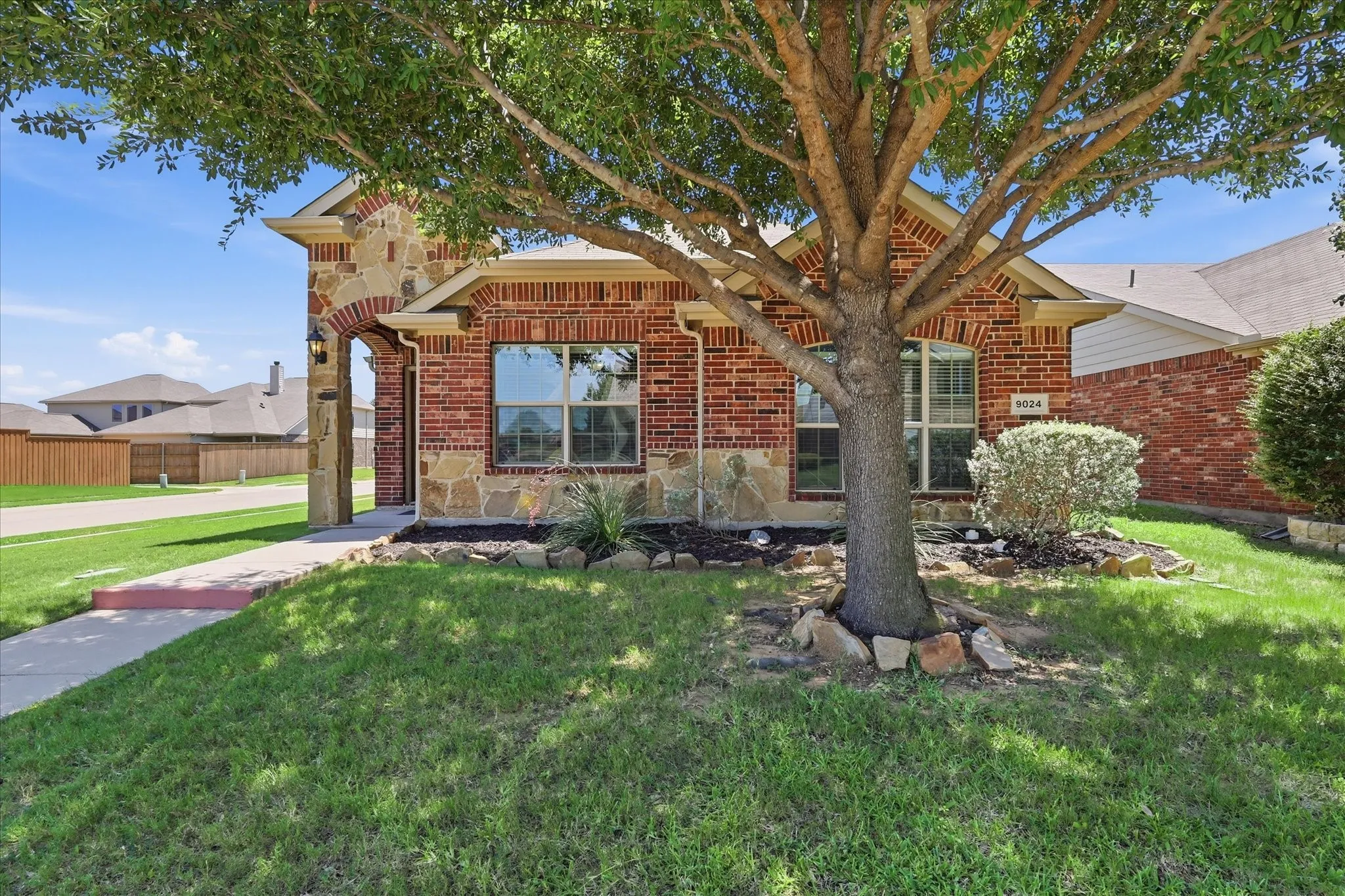 Brick and stone exterior with an arched entry