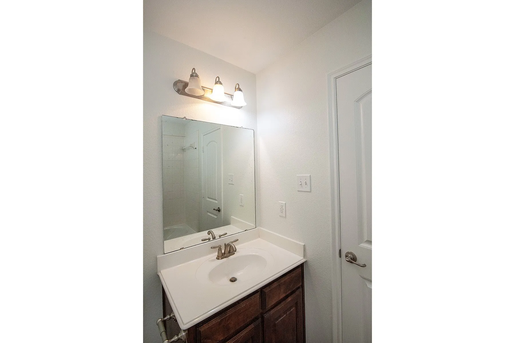 Bathroom vanity with a white countertop and integrated sink