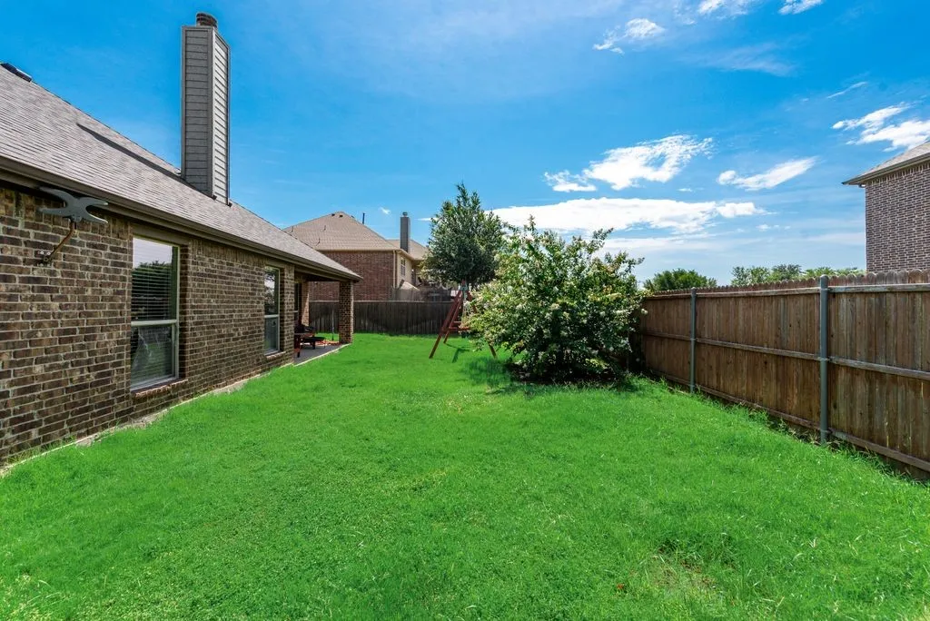 Manicured lawn with a privacy fence